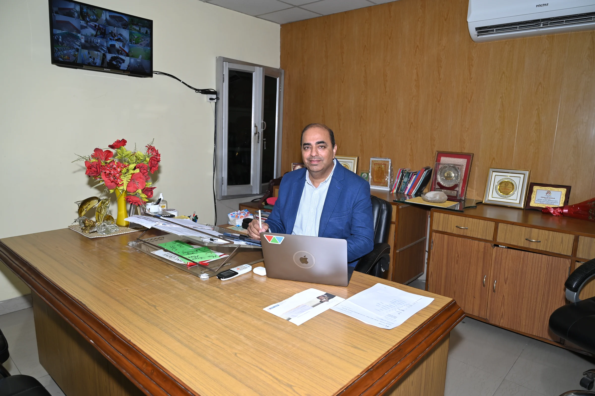 Dr. Vikas Kaushal, Managing Director of the Pine Grove Group of Institutes, seated in his office.