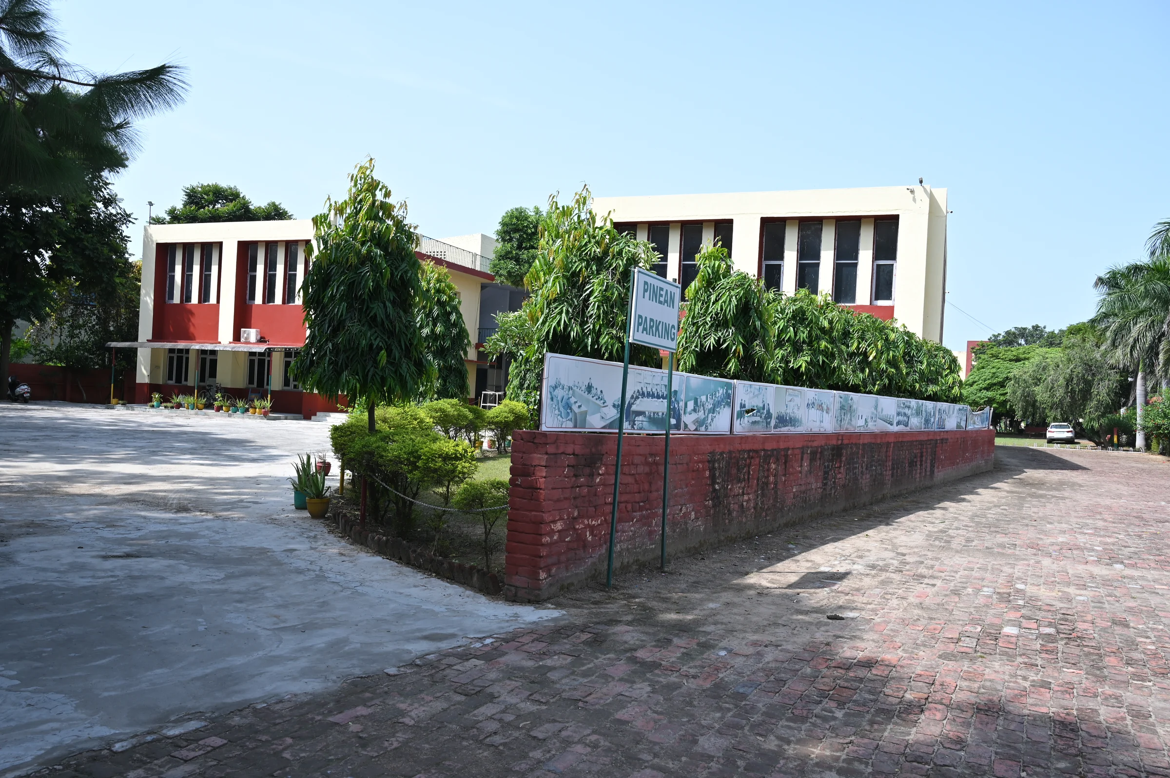 A Pine Grove college academic block seen from the broad paved courtyard.