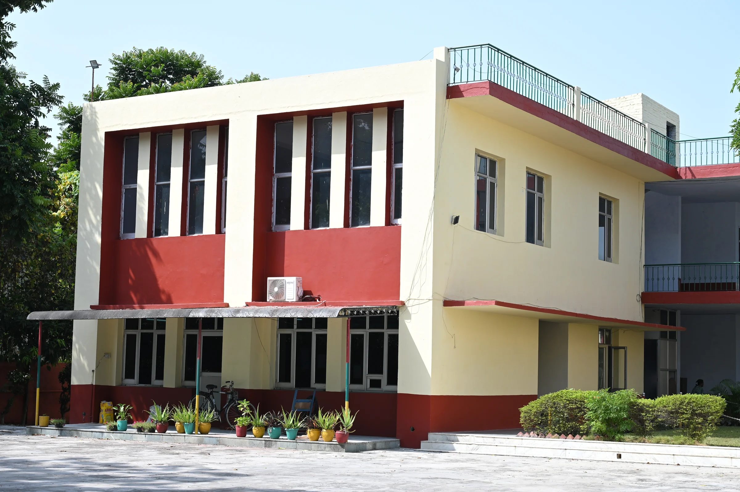 A clear view of a Pine Grove college academic building and planted courtyard.