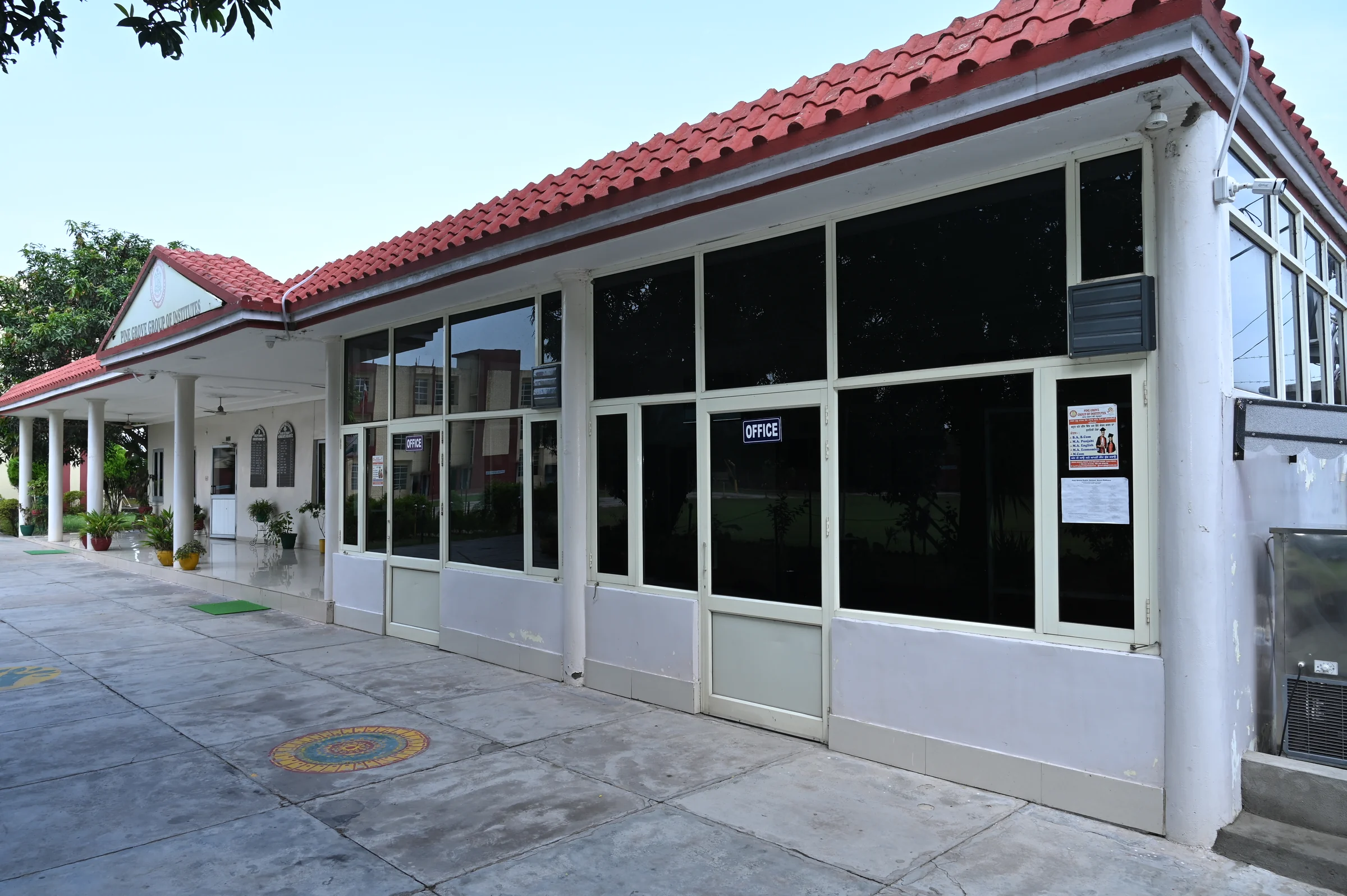 The glass-fronted reception building at Pine Grove Public School, Bassi Pathana.