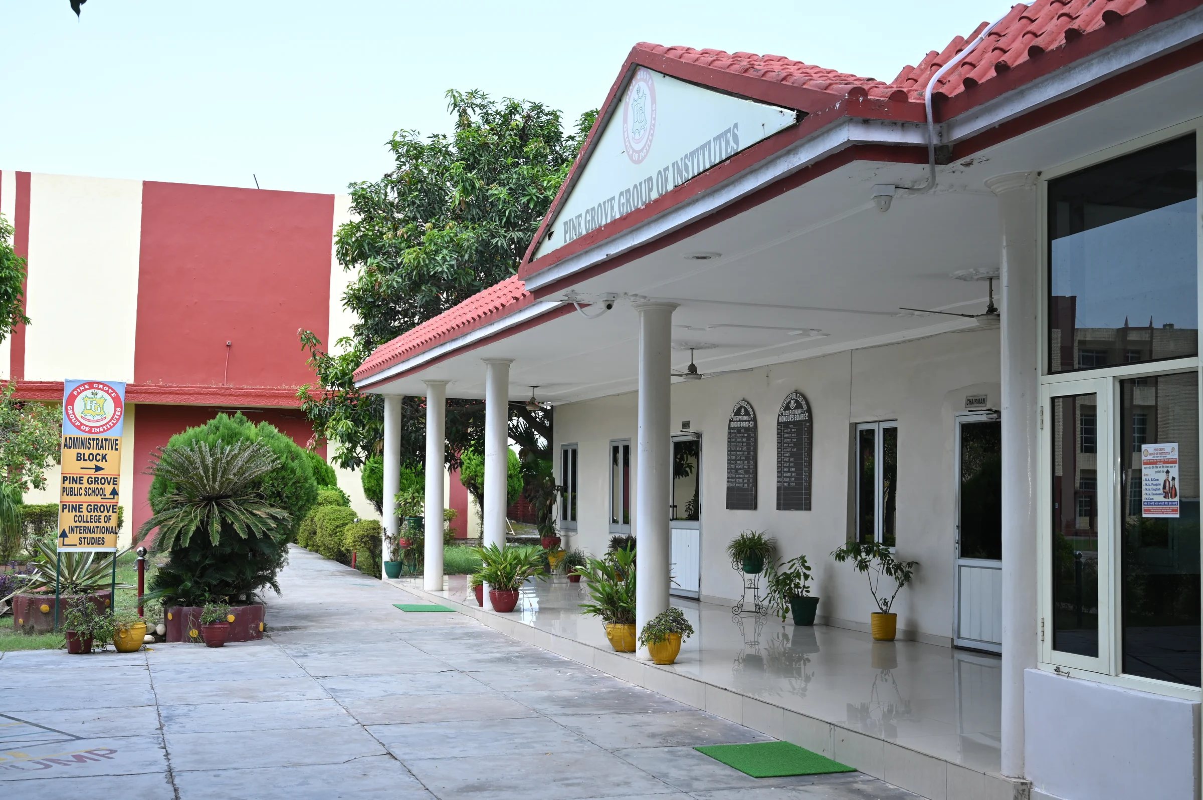 The reception courtyard at Pine Grove Public School, Bassi Pathana, with the covered veranda and school block beyond.