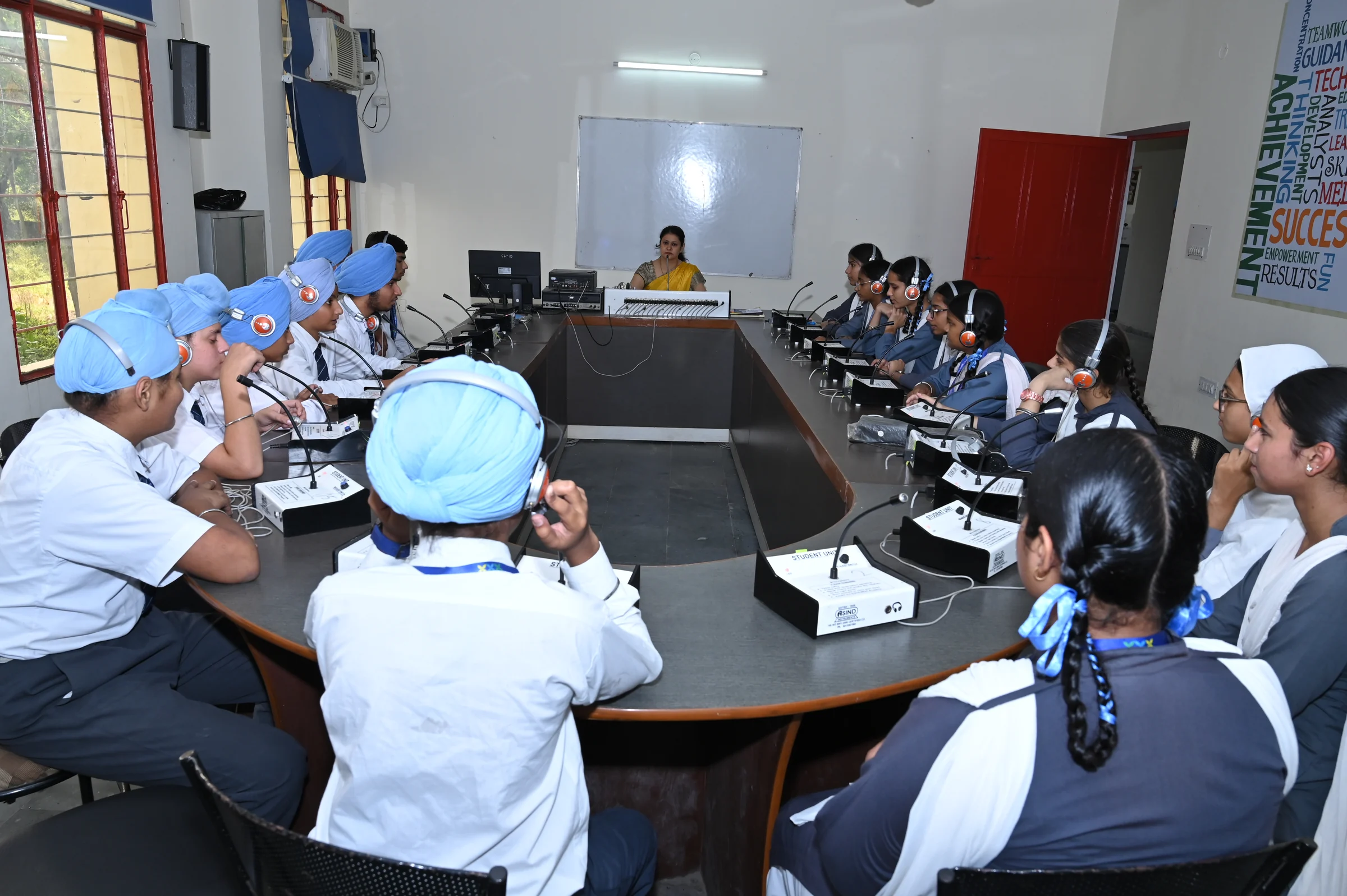 Students listening and taking notes during a group seminar discussion.